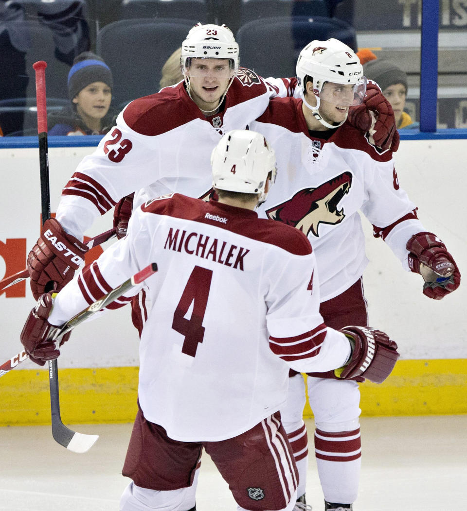 Arizona Coyotes&#39; Oliver Ekman-Larsson (23), Tobias Rieder (8) and Zbynek Michalek (4) celebrate a goal against the Edmonton Oilers during the second period of an NHL hockey game in Edmonton, Alberta., on Monday, Dec. 1, 2014. (AP Photo/The Canadian Press, Jason Franson)