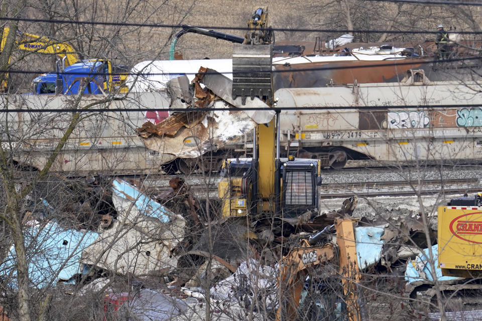 Workers continue to clean up remaining tank cars, Tuesday, Feb. 21, 2023, in East Palestine, Ohio, following the Feb. 3 Norfolk Southern freight train derailment. (AP Photo/Matt Freed)