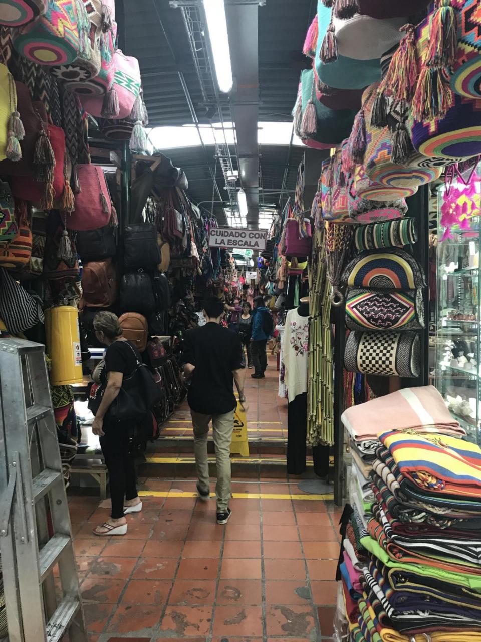 Mochila bags hang in an artisan market