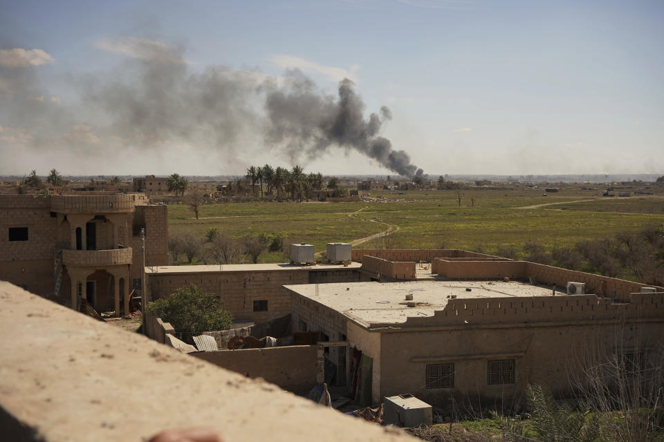 Columns of black smoke billow from the last small piece of territory held by Islamic State militants as U.S. backed fighters pounded the area with artillery fire and occasional airstrikes in Baghouz, Syria, Sunday, March 3, 2019. (AP Photo/Andrea Rosa)