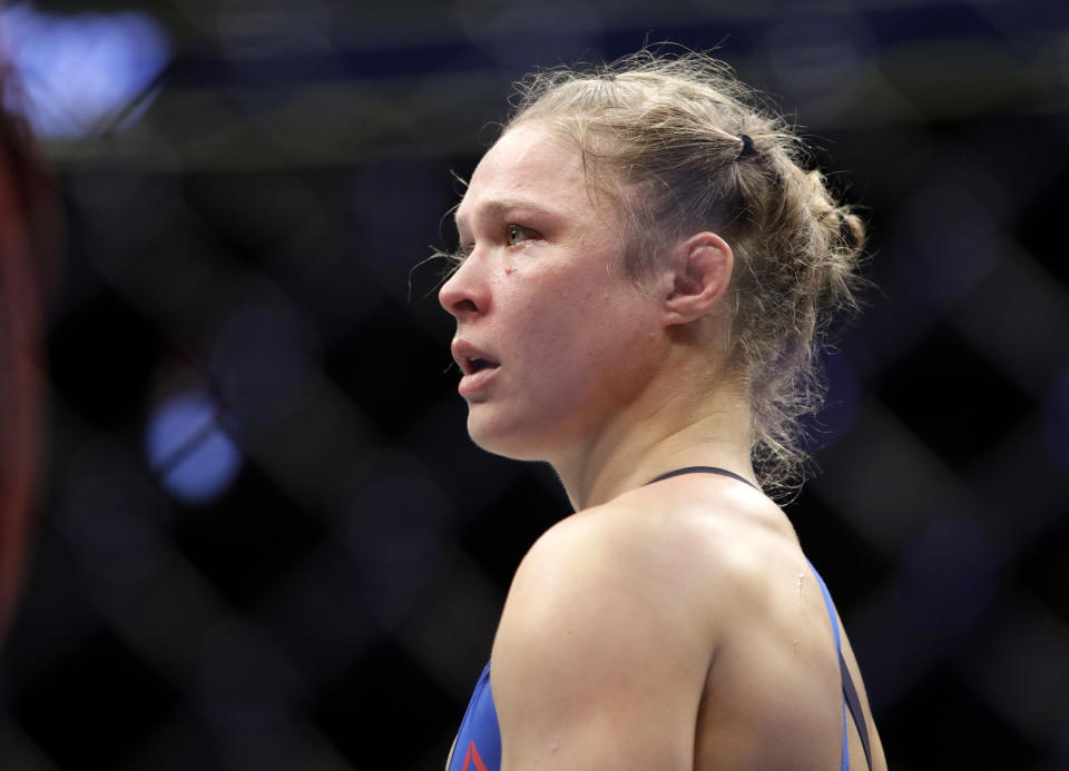 Ronda Rousey stands in the cage after Amanda Nunes forced a stoppage in the first round of their women's bantamweight championship mixed martial arts bout at UFC 207, Friday, Dec. 30, 2016, in Las Vegas. (AP Photo/John Locher)
