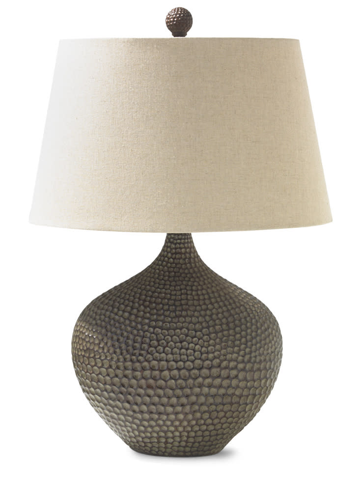 This publicity product photo from HomeGoods.com shows a hammered wood base lamp. Carved, weathered and washed woods are a strong trend this fall, in furniture and tabletop décor. (AP Photo/HomeGoods)