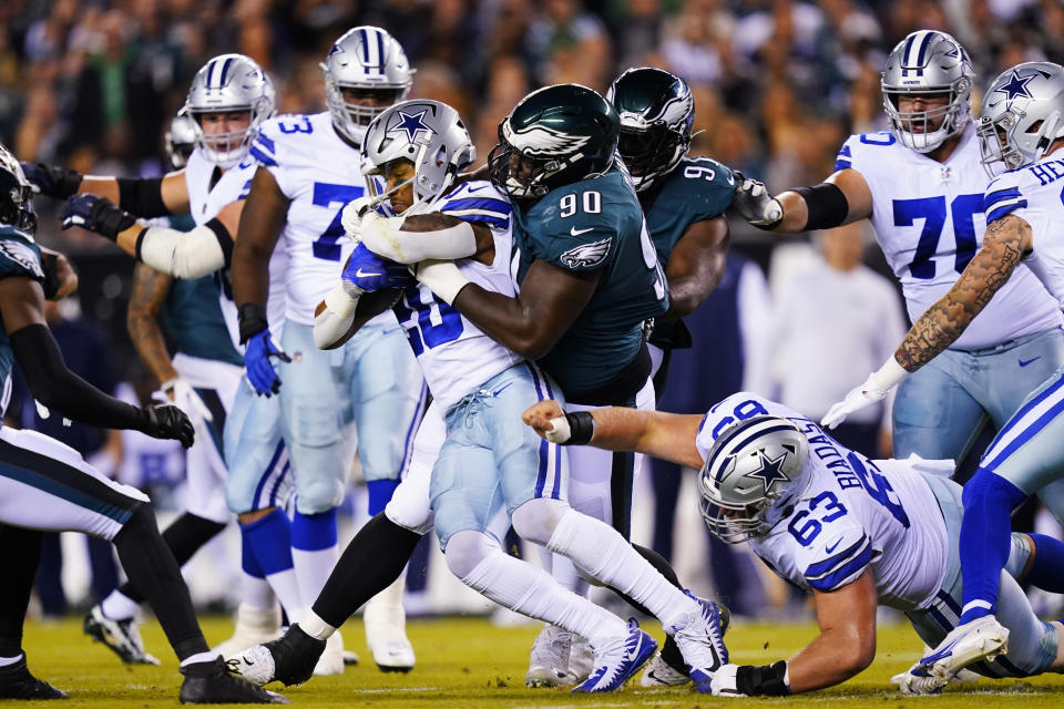 Dallas Cowboys' Tony Pollard is tackled by Philadelphia Eagles' Jordan Davis (90) during the first half of an NFL football game Sunday, Oct. 16, 2022, in Philadelphia. (AP Photo/Matt Slocum)