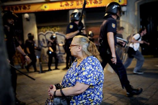 Riot policemen patrol in Madrid after a protest against the Spanish government's latest austerity measures, on July 19, 2012. Riot police have charged protestors in Madrid, striking them with batons when they tried to reach the heavily-guarded parliament building