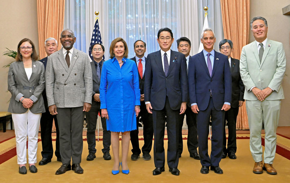 U.S. House of Representatives Speaker Nancy Pelosi and other delegates pose for a photograph with Japan's Prime Minister Fumio Kishida before their breakfast meeting at Kishida's residence in Tokyo, Japan August 5, 2022, in this photo released by Kyodo. Mandatory credit Kyodo via REUTERS ATTENTION EDITORS - THIS IMAGE WAS PROVIDED BY A THIRD PARTY. MANDATORY CREDIT. JAPAN OUT. NO COMMERCIAL OR EDITORIAL SALES IN JAPAN