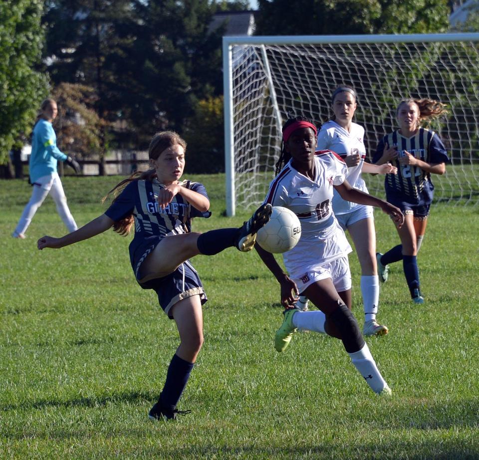 St. Maria Goretti's Bella Maciulla knocks the ball down in front of Saint James' Averey Ndong-Cantave during Friday's Washington County girls soccer game at Fairgrounds Park.