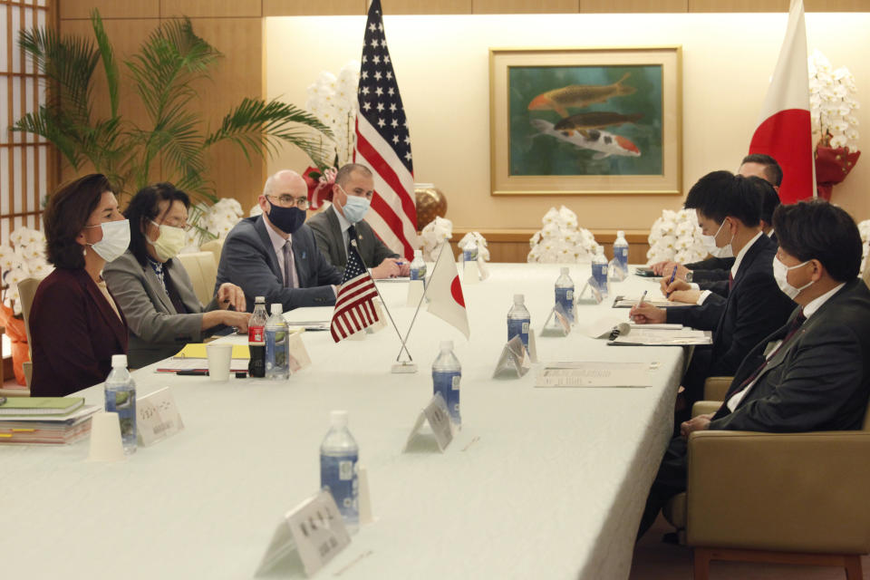 U.S. Commerce Secretary Gina Raimondo, left, talks with Japanese Foreign Minister Yoshimasa Hayashi, right, during their meeting in Tokyo, Monday, Nov. 15, 2021. U.S. and Japanese officials agreed Monday to launch talks aimed at settling a dispute over American tariffs on imports of Japanese steel and aluminum. (AP Photo/Koji Sasahara, Pool)