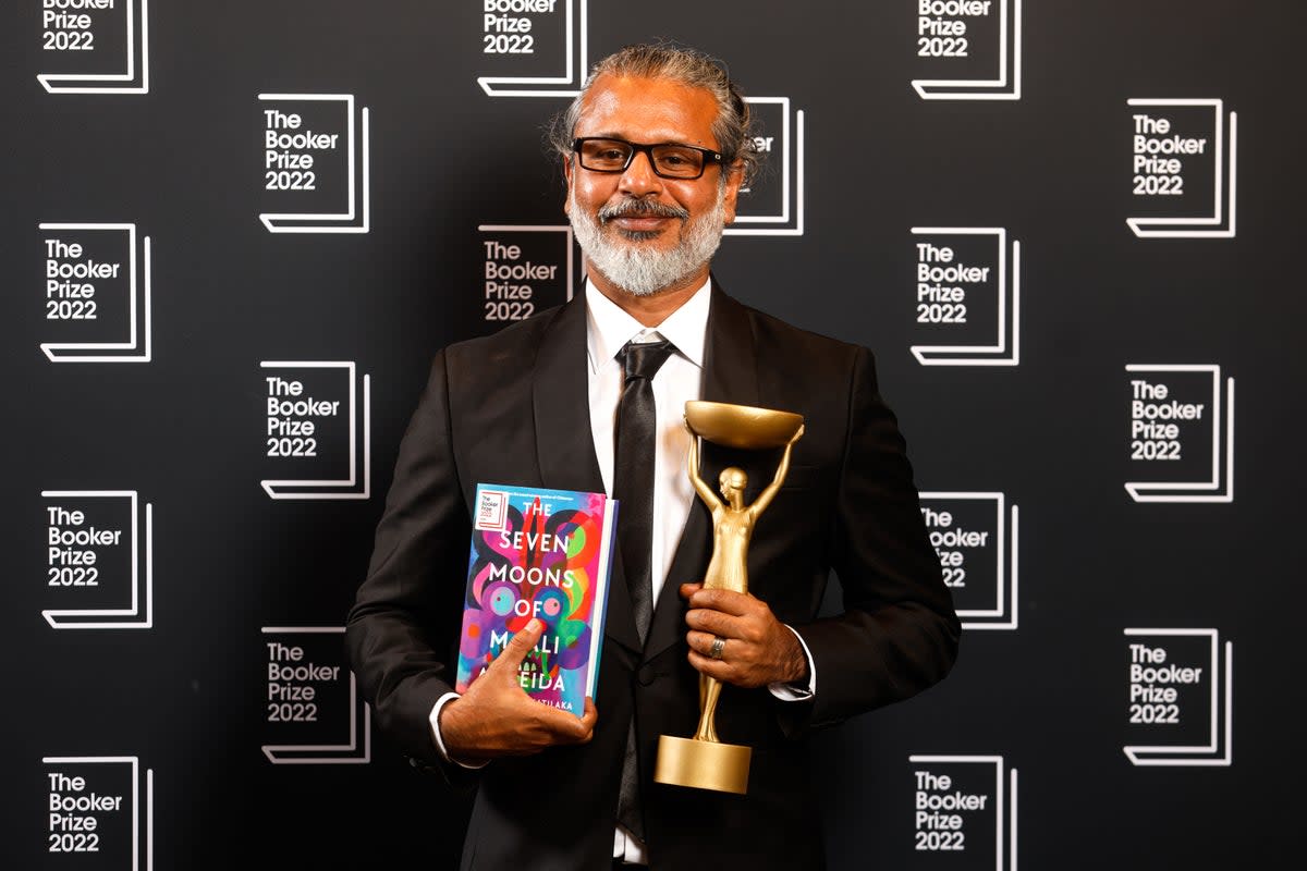 Winning author Shehan Karunatilaka with his trophy and book (David Parry/PA) (PA Wire)