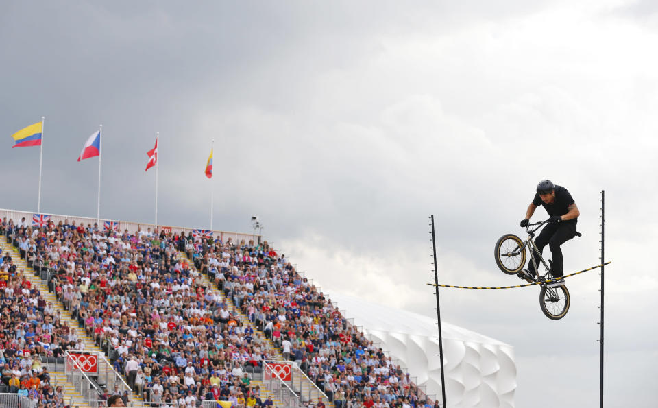 A freestyler entertains the crowd between races during the BMX seeding run at the London 2012 Olympic Games at the BMX Track in the Olympic Park