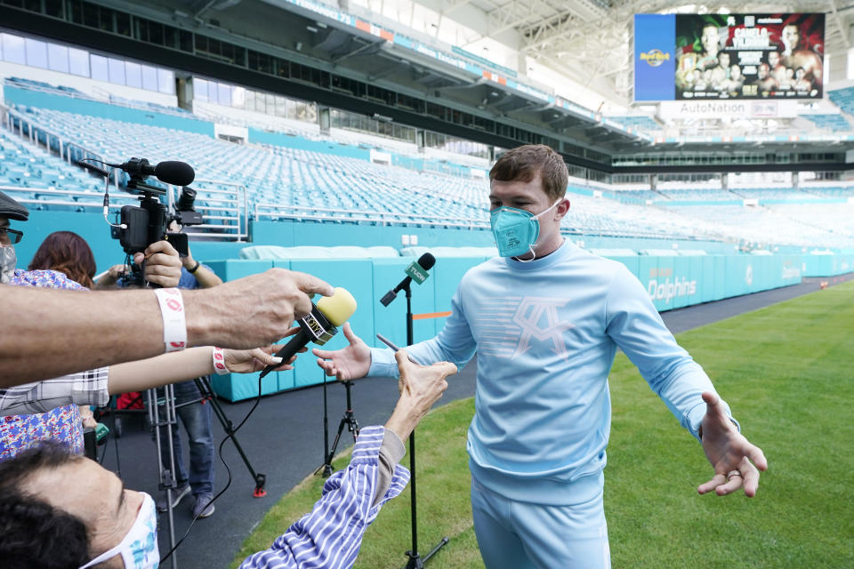 Saul "Canelo" Alvarez speaks to the press at Hard Rock Stadium, Monday, Feb. 22, 2021, in Miami Gardens, Fla. Alvarez will defend his WBC and WBA super middleweight titles against challenger Avni Yildirim on Saturday. (AP Photo/Marta Lavandier)