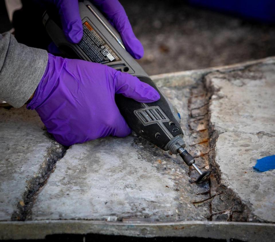 A technician from RLA Conservation carefully digs into the concrete and rusted steel rebar in the back of a section of a 1950s Miami Beach mosaic mural that is undergoing restoration at Wynwood’s Bakehouse Art Complex. The mural, which depicts the Greek god Apollo, was rescued from destruction by preservationists in 2015. Jose A. Iglesias/jiglesias@elnuevoherald.com