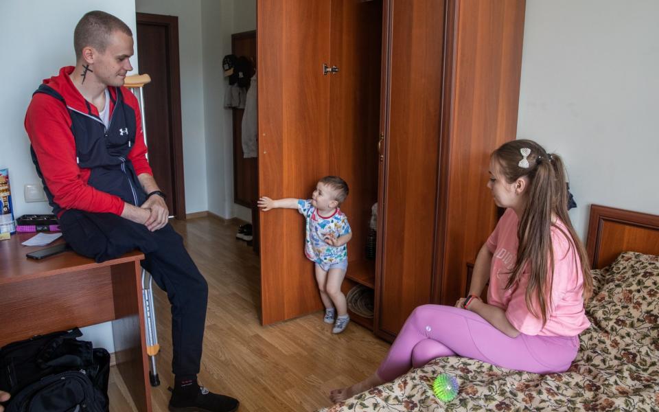 Serhiy Pasechnik, 26, his wife Liza Pasechnik, 24, and their son Yegor, 2, smile as they speak to the Daily Telegraph, at the Halychyna Complex Rehabilitation Center in Lviv, Ukraine on June 3, 2022. - Oleksander Khomenko/Oleksander Khomenko