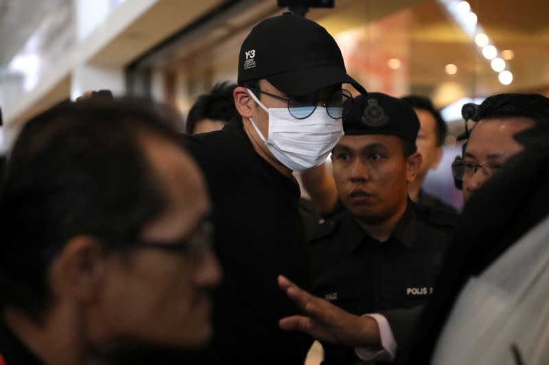 Japanese badminton player Kento Momota arrives at Kuala Lumpur International Airport, as he leaves for Tokyo, after he was released from hospital following an injury in a vehicle collision on Monday, in Sepang