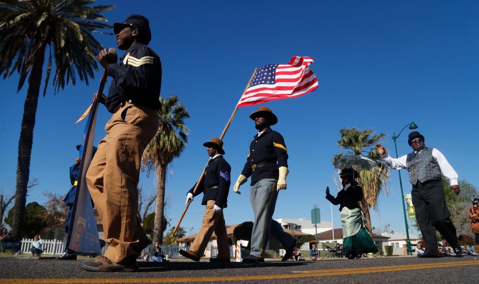 Buffalo Soldiers of Arizona come down a parade route during the MLK Day Parade on Jan. 21, 2019, in Mesa, Ariz.
