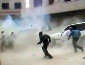 An image grab from video footage uploaded on Youtube allegedly shows Syrians running for cover as a roadside bomb explodes in front of a UN observers convoy in Khan Sheikhun between the cities of Hama and Idlib, without causing any injuries, according to UN officials