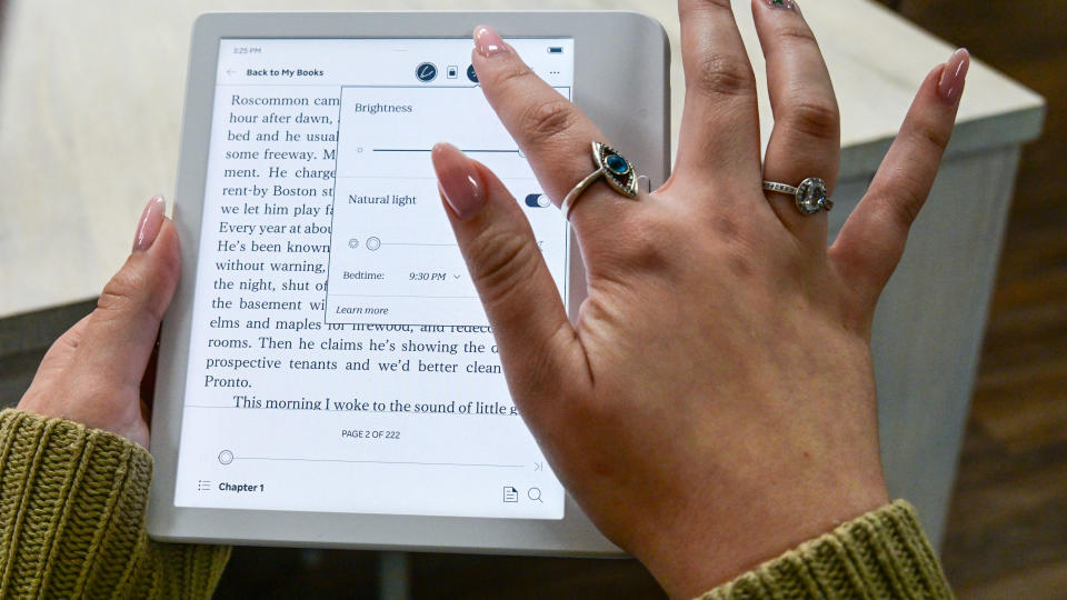 A person making brightness adjustments on the Kobo Libra Colour ereader