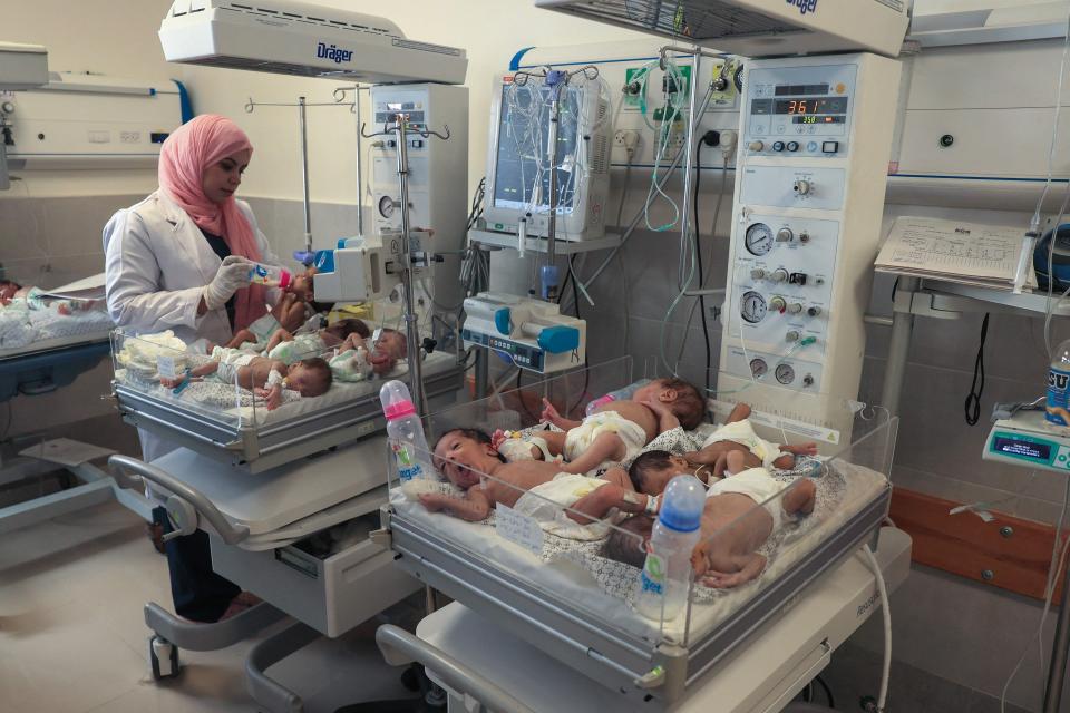 A Palestinian medic cares for premature babies, evacuated from Gaza City's Al Shifa Hospital, ahead of their transfer from a hospital in Rafah in the southern Gaza Strip to Egypt, on November 20, 2023, amid ongoing battles between Israel and the militant group Hamas.