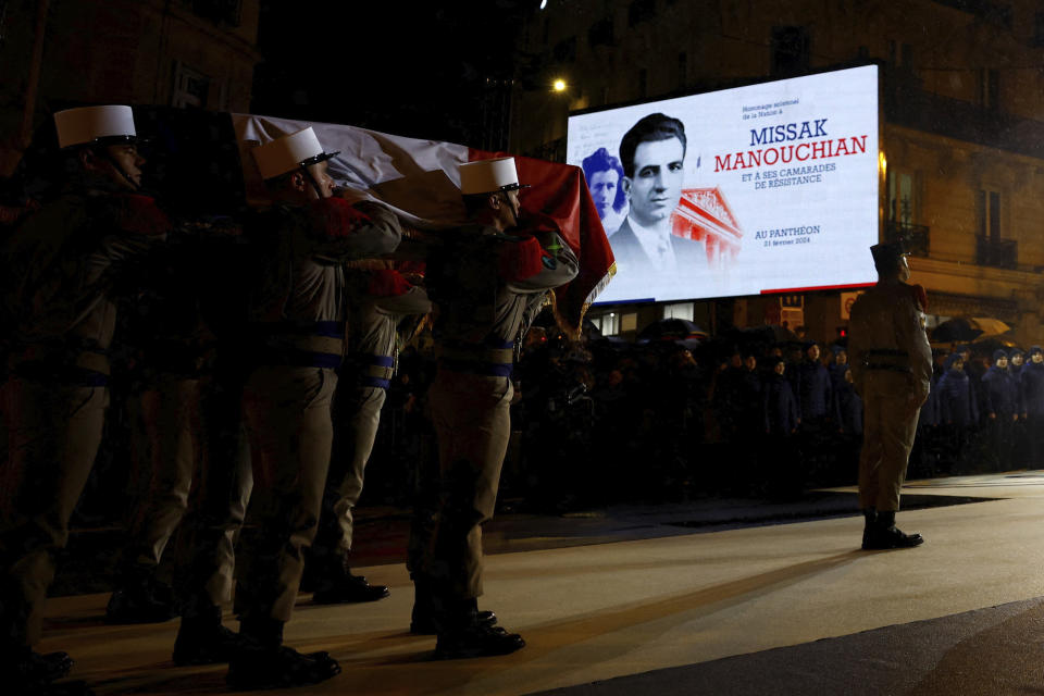 Soldiers from French Foreign Legion carry the coffin of Missak Manouchian during his induction ceremony and his 23 resistance fighters into the Pantheon monument, Wednesday, Feb 21, 2024 in Paris. A poet who took refuge in France after surviving the Armenian genocide, Manouchian was executed in 1944 for leading the resistance to Nazi occupation. (Sarah Meyssonnier/Pool via AP)