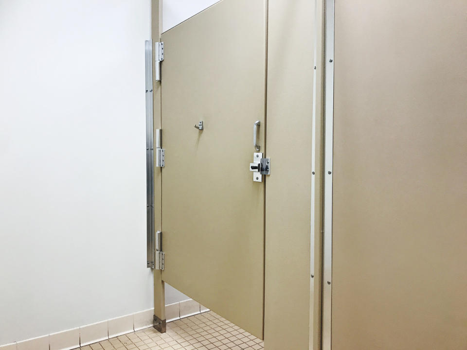 Public bathroom stalls with large gaps.