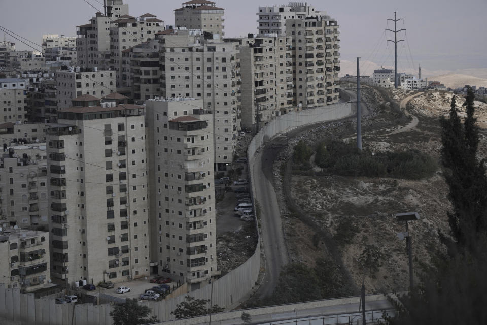 The besieged Shuafat refugee camp in east Jerusalem, Thursday, Oct. 13, 2022. It was the site of fierce clashes after Israeli security forces set up checkpoints that choked off the only exit and entry points of the camp during a manhunt following the death of a soldier, bringing life to a standstill for its estimated 60,000 residents. (AP Photo/Mahmoud Illean)