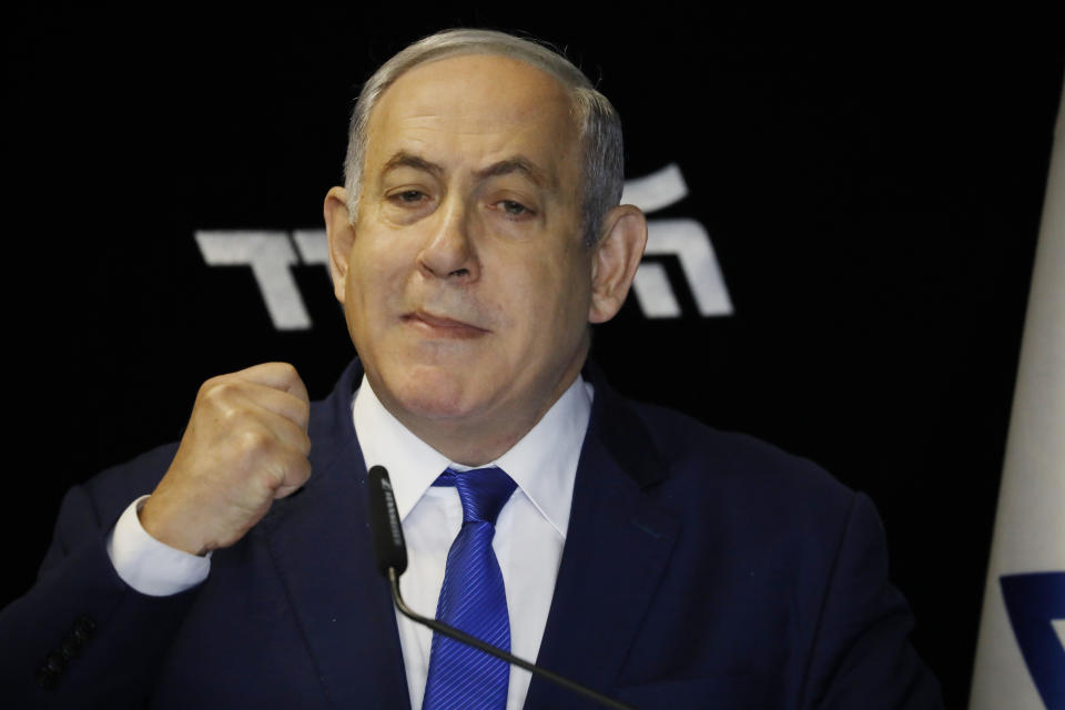Israeli Prime Minister Benjamin Netanyahu deliverers a statement at the airport city in Lod Israel, Friday, Dec. 27, 2019. Netanyahu shored up his base with a landslide primary victory announced early Friday, but he will need a big win in national elections in March if he hopes to stay in office and gain immunity from prosecution on corruption charges. (AP Photo/Ariel Schalit)