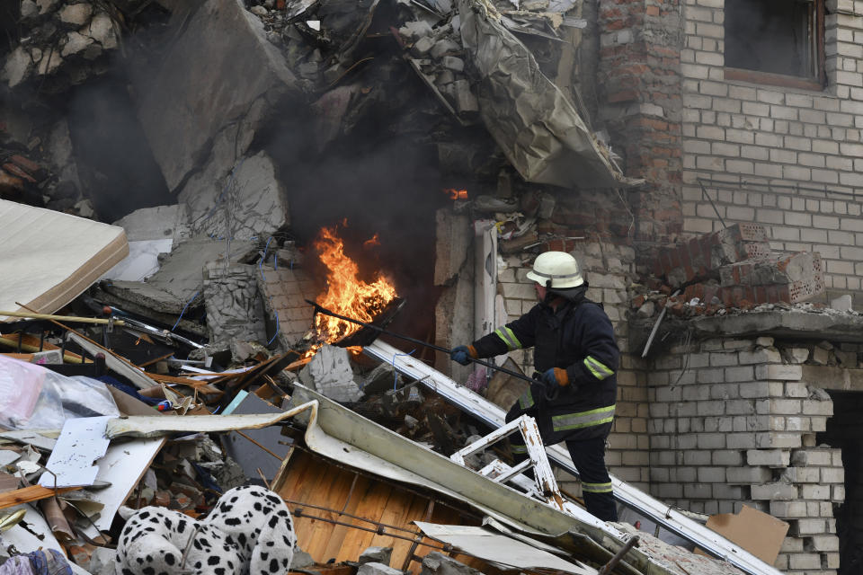 A firefighter works at the scene of a damaged residential building after Russian shelling in the liberated Lyman, Donetsk region, Ukraine, Monday, Nov. 7, 2022. (AP Photo/Andriy Andriyenko)