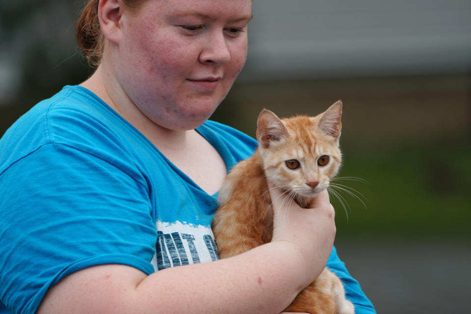 A woman carries her cat on a flooded street after Hurricane Florence struck Piney Green, North Carolina, U.S., September 16, 2018.