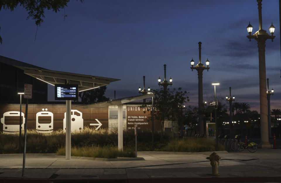 An empty Metro bus stops is seen next to Union Station in Los Angeles late afternoon Tuesday, Jan. 5, 2021. Los Angeles is the epicenter of California's surge that is expected to get worse in coming weeks when another spike is expected after people traveled or gathered for Christmas and New Year's. (AP Photo/Damian Dovarganes)