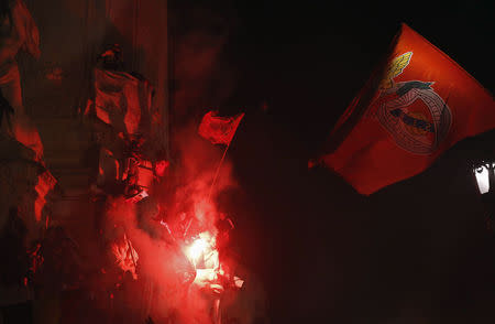 Benfica's supporters hold flags at the top of Marques Pombal statue after beating Olhanense and winning the Portuguese Premier League title, in Lisbon April 20, 2014. REUTERS/Hugo Correia