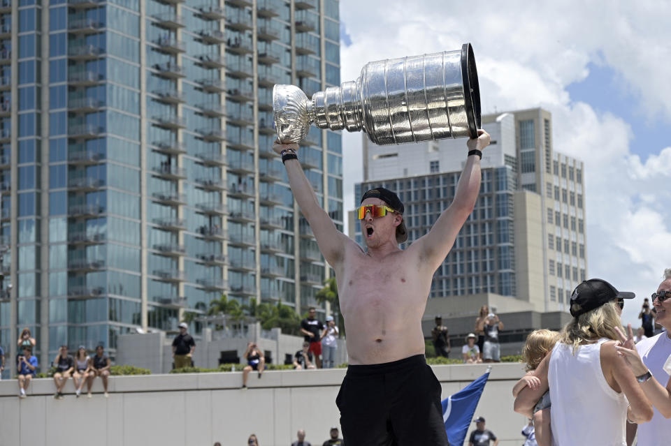 Tampa Bay Lightning center Blake Coleman hoists the Stanley Cup during the NHL hockey Stanley Cup champions' Boat Parade, Monday, July 12, 2021, in Tampa, Fla. (AP Photo/Phelan M. Ebenhack)