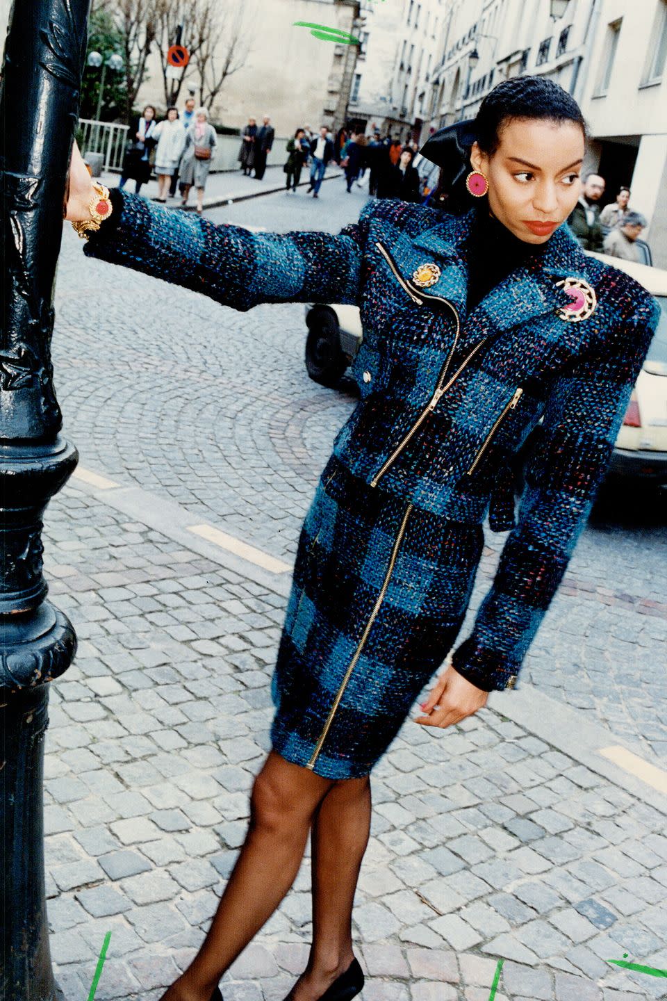 <p>A model dons a blue tweed skirt suit on the street. </p>