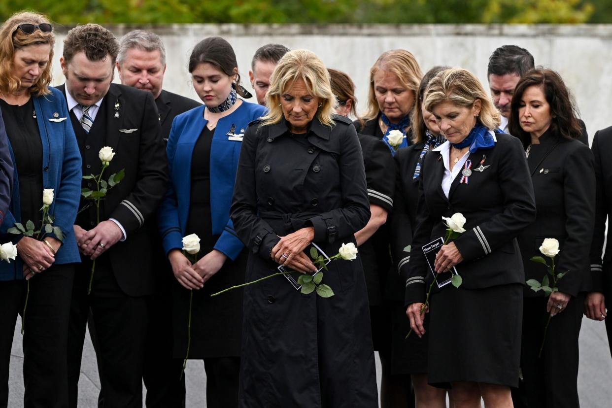 First lady Jill Biden participates in a moment of silence with the members of the Association of Flight Attendants at the Flight 93 National Memorial Wall of Names following a ceremony commemorating the 21st anniversary of the Sept. 11, 2001 terrorist attacks in Shanksville, Pa., Sunday, Sept. 11, 2022. (AP Photo/Barry Reeger)