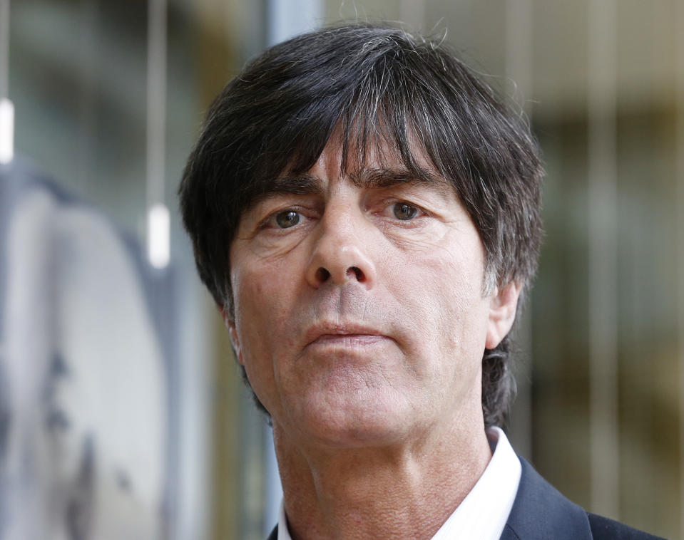 Coach of the German national soccer team Joachim Loew is on his way to a press conference where he will present his preliminary team for the upcoming World Cup in Brazil in Frankfurt, Germany, Thursday, May 8, 2014. (AP Photo/Michael Probst)