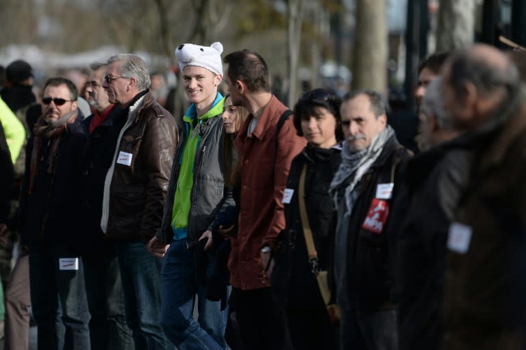 People form a human chain in Nantes on November 28, 2015 during a protest over the ban on public gatherings until November 30, the start of UN climate talks COP21