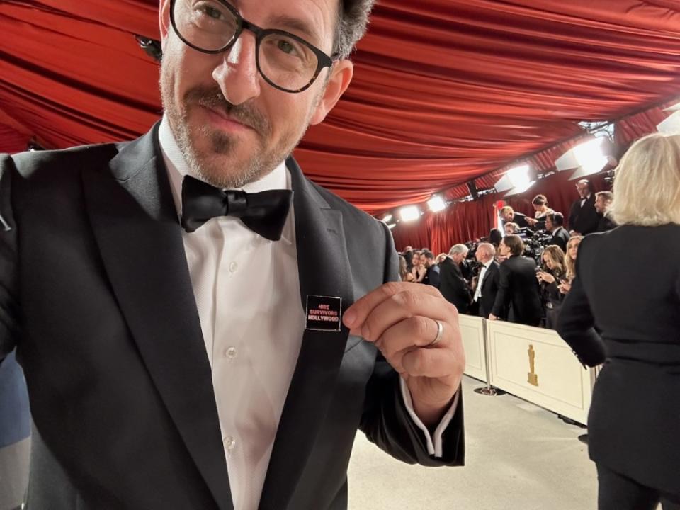 “She Said” actor Adam Shapiro wearing a Hire Survivors Hollywood pin at the 2023 Academy Awards