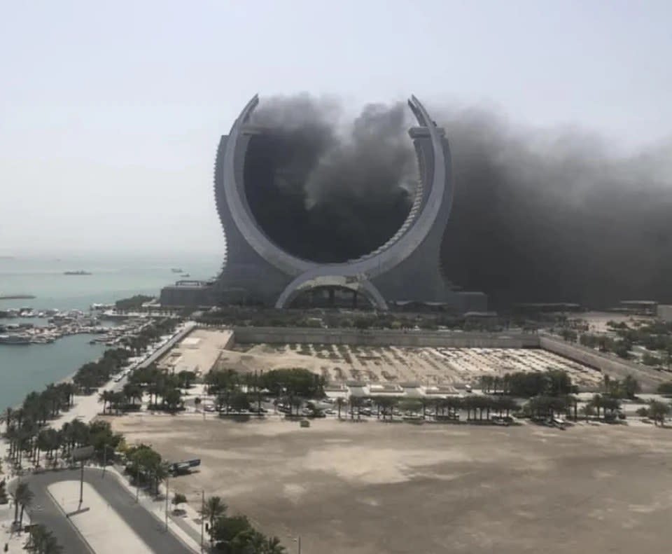 a half-moon shaped tower that has lots of smoke coming out of the middle