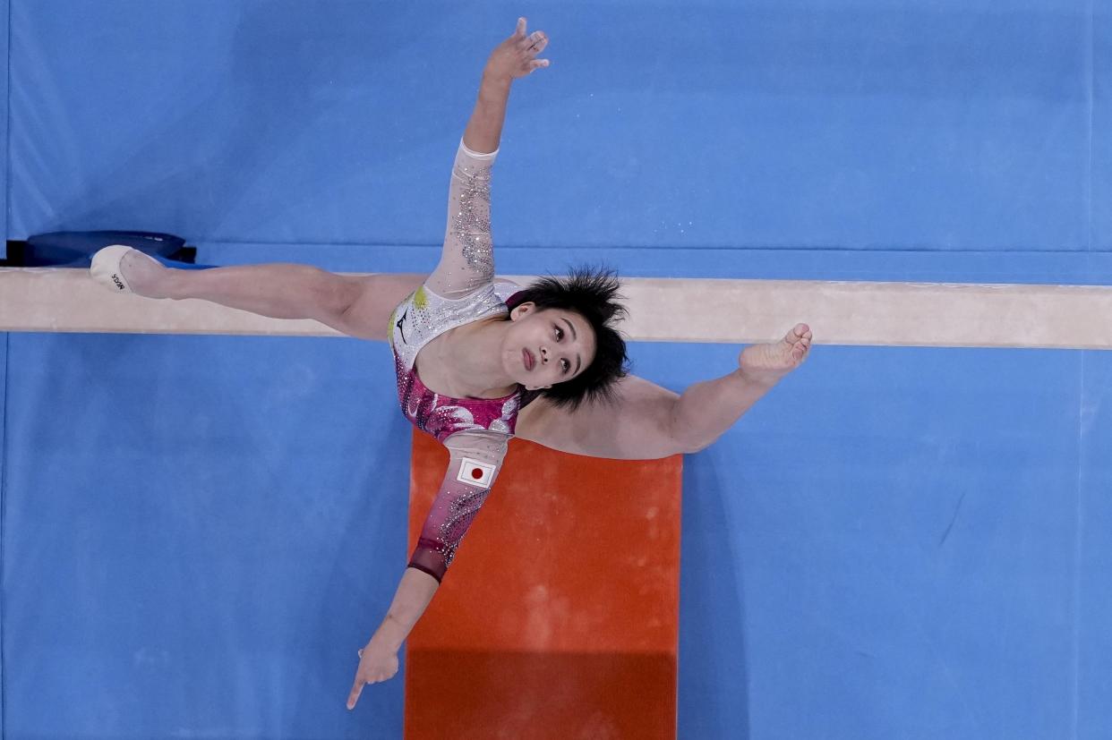 Mai Murakami, of Japan, performs on the beam during women's artistic gymnastic qualifications at the 2020 Summer Olympics, Sunday, July 25, 2021, in Tokyo.