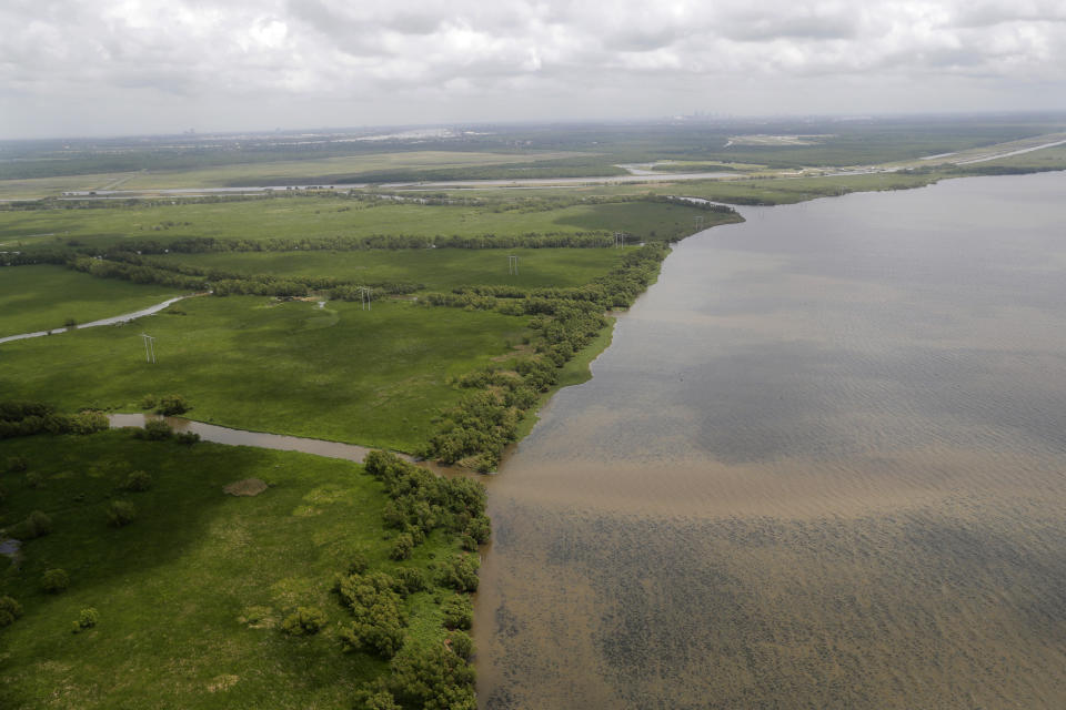 FILE - This May 1, 2019, file photo shows the Davis Pond Diversion emptying into Lake Cataouache, with tree growth on the edges of the channels in St. Charles Parish, La. A nearly $2 billion plan to divert water and sediment from the Mississippi River to rebuild land in southeastern Louisiana, a proposal considered the cornerstone of the state's efforts to protect its rapidly eroding coast, has passed a major milestone with the publication of the Army Corps of Engineers long-awaited environmental impact study, Thursday, March 4, 2021. (AP Photo/Gerald Herbert, File)