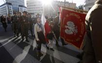 Participants hold flags as they take part in a march, organized by far-right organizations, to honour former Polish, anti-Soviet and anti-Nazi National Armed Forces (NSZ) in Warsaw September 21, 2013. Picture taken September 21, 2013. REUTERS/Kacper Pempel