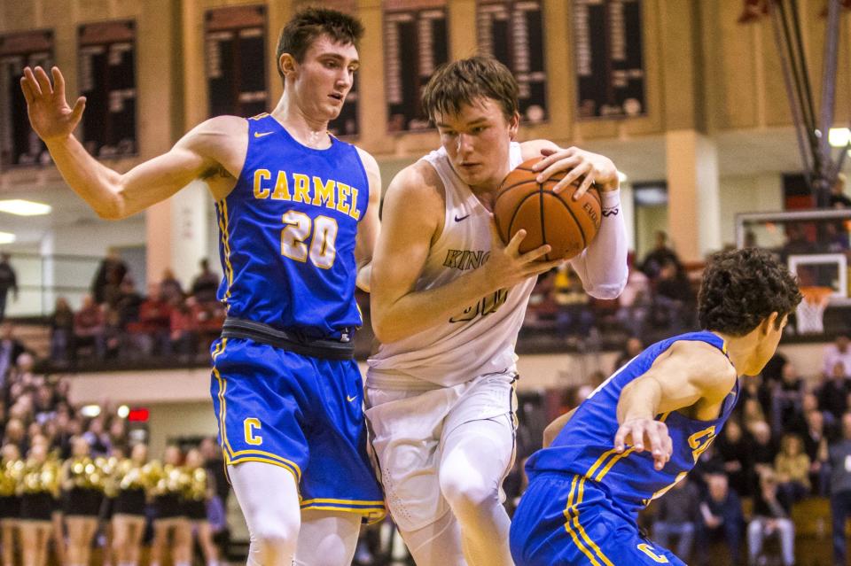 Penn’s Noah Applegate, center, moves between Carmel’s Andrew Owens, left, and Luke Heady during a semistate game on March 16, 2019 at Jefferson High School in Lafayette, Ind.
(Tribune File Photo)