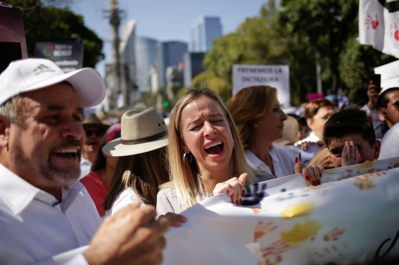 Members of the LeBaron family, part of the Mexican-American Mormon community who saw nine of its members murdered in November, react during a march to protest against violence on the first anniversary of President Andres Manuel Lopez Obrador taking office