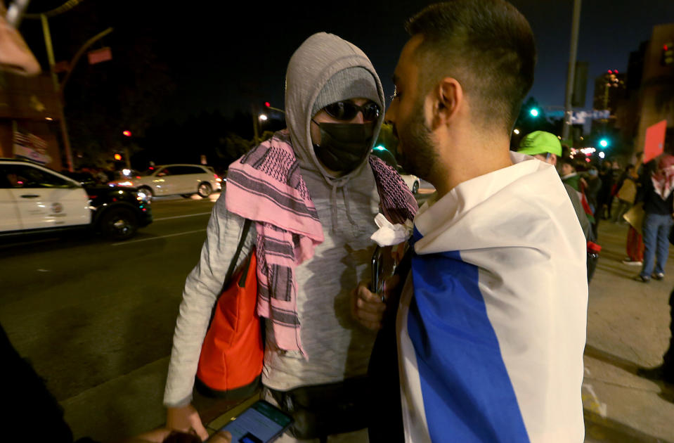 Los Angeles, CA - A supporter of Paletine, left, faces poff agaonst a supporter of Israel outside of The Museum of Tolerance in Los Angeles on Wednesday, Nov. 8, 2023. The museum held a private screening of footage documenting the Hamas invasion of Israel on Oct. 7th. Supporters of Palestine protested across the street outside.(Luis Sinco / Los Angeles Times)