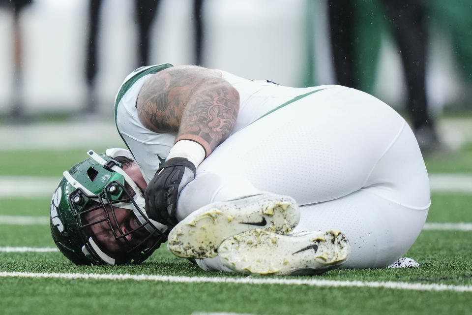 New York Jets center Connor McGovern (60) lies no the field with an apparent injury during the first half of an NFL football game against the New York Giants, Sunday, Oct. 29, 2023, in East Rutherford, N.J. (AP Photo/Frank Franklin II)