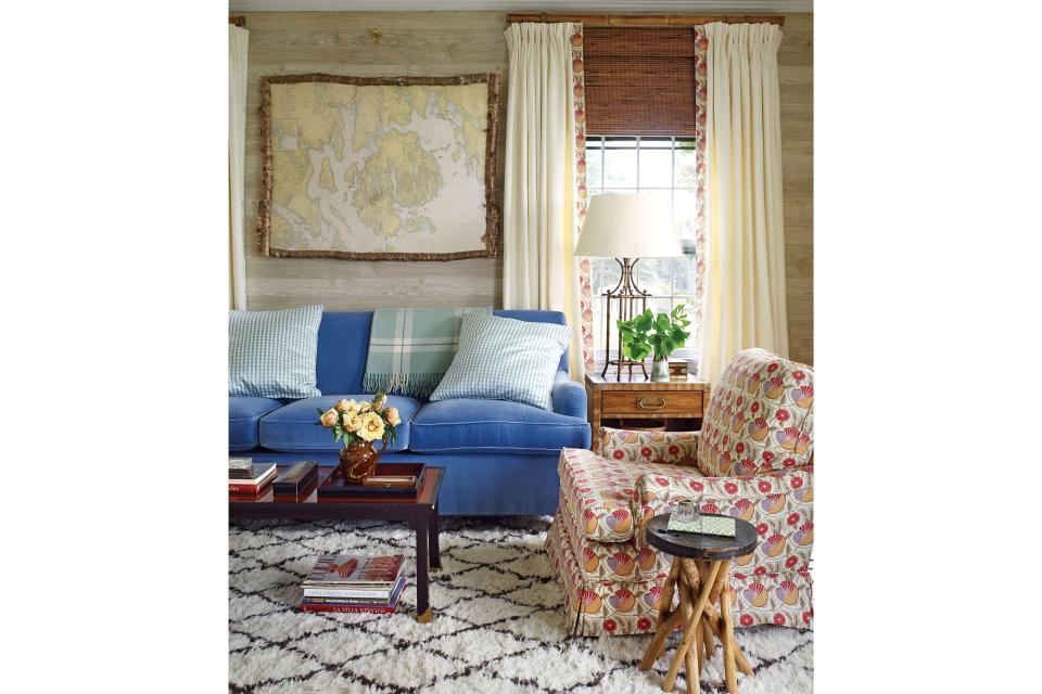 <p>To channel that aesthetic and put a more New England spin on her signature tropical style, Lindroth turned to a decorating legend for inspiration. "My mantra for this project was, "What would Sister Parish do?"" she says. Parish's beach house in Dark Harbor, Maine—where the interiors were known for their "undecorated" decor and coziness via mix-and-match patterns—was Lindroth's guiding light.</p> <p><i>Pictured: French faux bois wallpaper by Nobilis hung in a horizontal orientation warms up the compact library without making it feel too dark. A nautical chart encased in a knobby birch frame and a deep-piled <a href="https://annieselke.com/c/dashandalbert" rel="nofollow noopener" target="_blank" data-ylk="slk:Dash & Albert;elm:context_link;itc:0;sec:content-canvas" class="link ">Dash & Albert</a> oushak rug add more texture.</i></p>