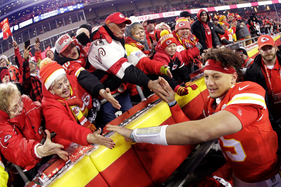 Fans congratulate Kansas City Chiefs quarterback Patrick Mahomes, right, as he comes off the field after an NFL divisional playoff football game against the Houston Texans, Sunday, Jan. 12, 2020, in Kansas City, Mo. (AP Photo/Charlie Riedel)