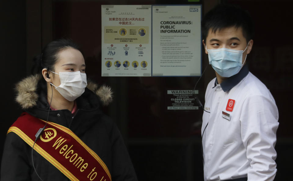 A man places an NHS coronavirus information poster in the window of a restaurant near China Town in London, Friday, Feb. 7, 2020. The director-general of the World Health Organization says a drop in the number of new coronavirus cases for two days is “good news” but cautions against reading too much into that. China reported 31,161 cases in mainland China in its update Friday. (AP Photo/Kirsty Wigglesworth)