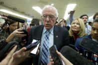 Sen. Bernie Sanders, I-Vt., talks to reporters as he arrives at the Senate for the start of the impeachment trial of President Donald Trump on charges of abuse of power and obstruction of Congress, at the Capitol in Washington, Tuesday, Jan. 21, 2020. (AP Photo/Jose Luis Magana)