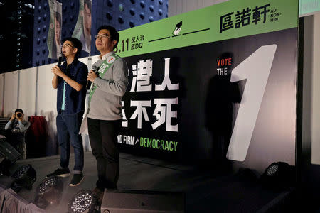 Pro-democracy candidate Au Nok-hin (R) and activist Joshua Wong attend an election campaign at the financial Central district in Hong Kong, China March 3, 2018. Picture taken March 3, 2018. REUTERS/Bobby Yip