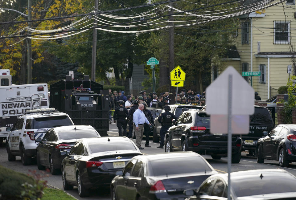 Law enforcement personnel gather at the scene where two officers were reported shot, Tuesday, Nov. 1, 2022, in Newark, N.J. Two officers were being treated for injuries at a nearby hospital, according to the Essex County prosecutor's office. (AP Photo/Seth Wenig)