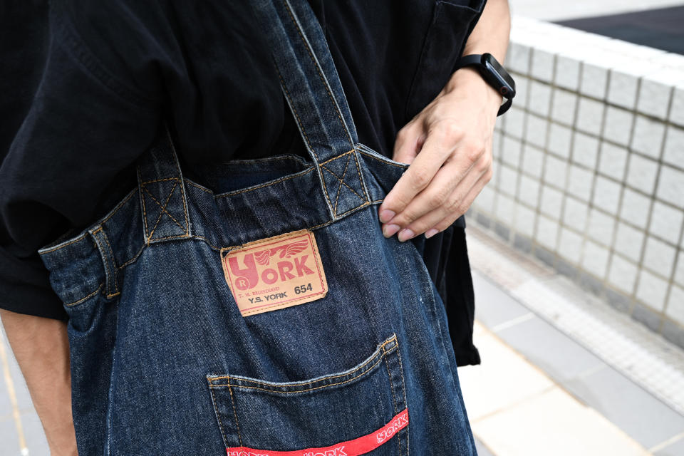 Carlos always carries a denim bag from Hong Kong's old fashion brand 